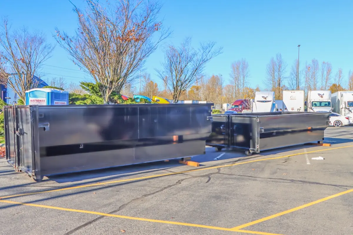 Professional dumpster rental service with roll-off container on residential driveway in Fishers